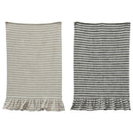 Striped cotton tea towels with ruffle bottom details in beige and black with white stripes. 