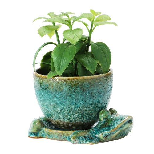 Stoneware Planter with Frog Base displayed with a plant on a white tabletop. 