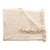 A Cozy Cotton Blend Boucle Throw with Fringe detail in a neutral off-white. 