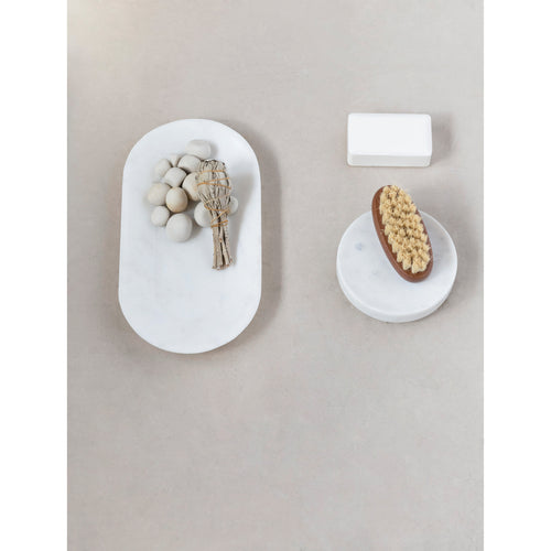Marble soap dish with scrub brush.