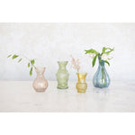 Colourful glassware debossed vases with fresh flowers. 