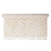 Stonewashed Cotton Tufted Rug with Geometric Pattern and Fringe in cream and mustard rolled up.