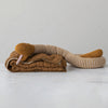 Cotton Knit Plush Snake with Stripes laying on top of a brown coloured quilt. 