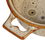 Reactive glaze details on the stoneware brie baker handle.