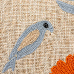 Up close detail of an embroidered bird on the Woven Cotton Lumbar Pillow.