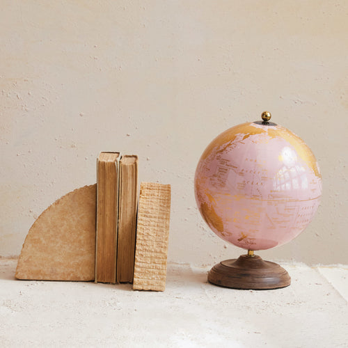 Pink & Gold Globe on Mango Wood Stand next to a stack of books. 