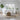 Modern living room with a white sofa, wooden coffee table, and decorative items.