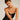 Woman wearing a black strapless dress against a plain background