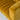 Close-up of a mustard yellow velvet sofa with a light gray background