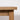 Close-up of a wooden table leg on a plain background