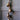 Four rustic iron bells on a jute rope strung to an antique door.