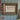 Framed artwork on a wall with decorative elements