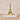 Gold Eiffel Tower model on a book with a beige background.