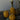 Three gourd shaped candles with white cotton wicks on a decorative surface.