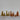 Green and brown paper trees with glitter set on a tabletop displayed as a forrest. 