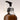 Brown spray bottle with a black pump head on a light gray background