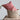 Hand Woven Basket with Handle styled with a red block printed patterned cushion placed inside. 