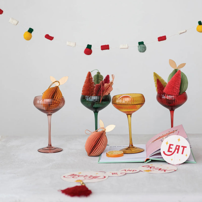 Filled with Cheer party with colorful stemmed coupe glasses. 