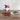 Gnome-shaped pitcher with a green and red melange cotton crocheted pot holders on a wooden surface.