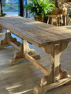 Sun shining in on a solid wood dining table. 