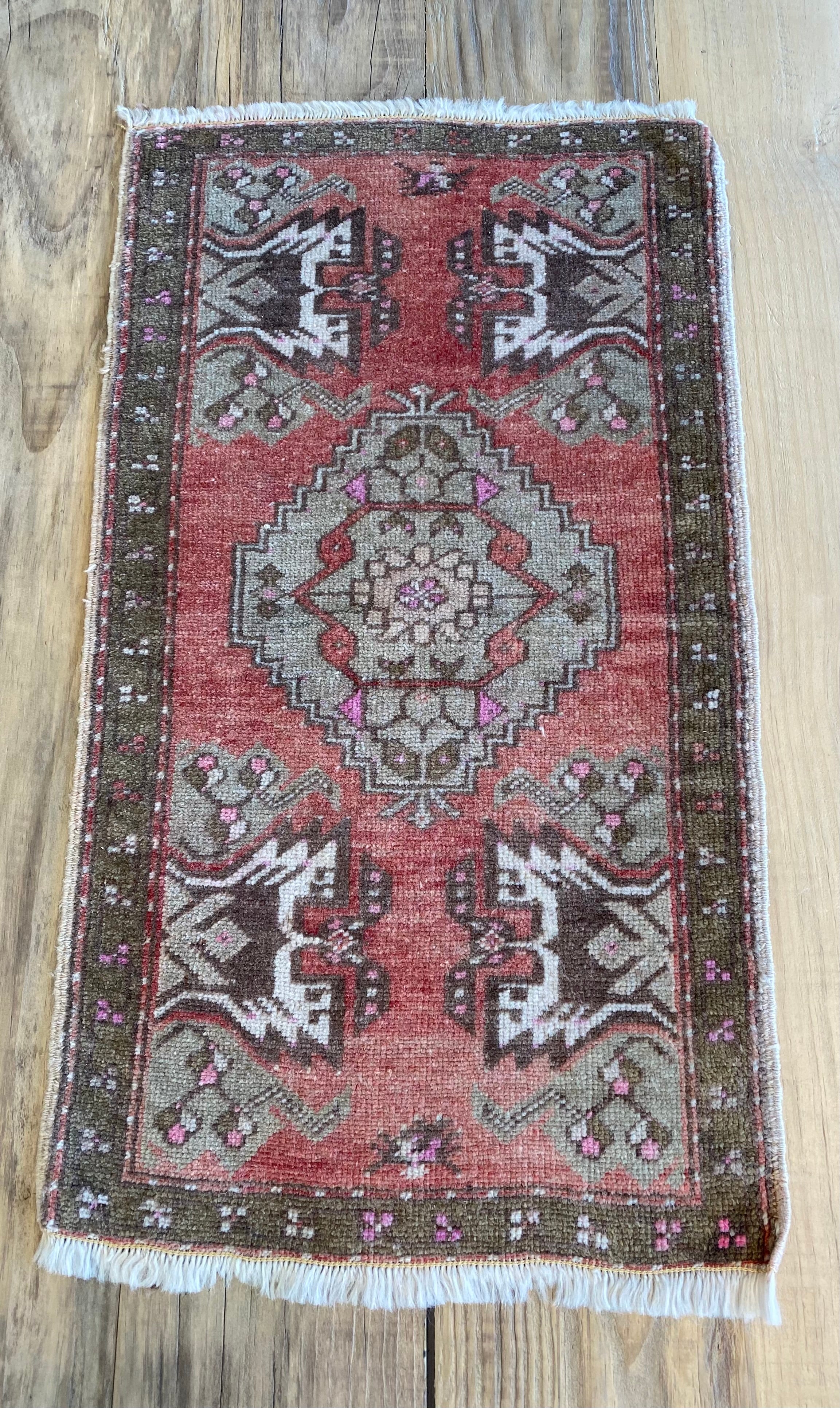 One of a kinf Turkish rug in red, pink and dark brown. 