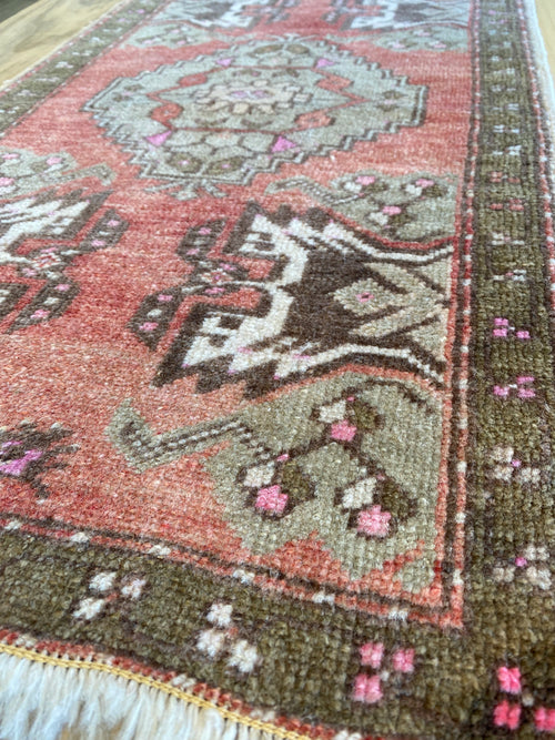 Up close view o the Rosy Red area rug showing the unique detail and colours. 
