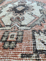 Close up photo showing the hand knotted workmanship and beautiful colours of the Earthy Tones and Pink rug. 