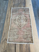 Turksih area rug in a faded pale pink with beige. 