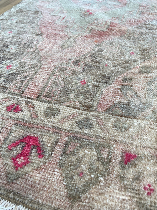 Pink accents and fringe detail on a Turkish area rug. 