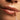 Close-up of a person applying lip serum with a brush