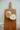 Two pears on a wooden cutting board with a textured white background