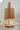 Wooden cutting board with two pears on a textured surface