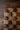 Wooden checkerboard with dark wood checkers on a wooden surface
