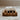 Bar of soap on a wooden soap dish with a blurred background