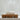 Wooden soap dish with a bar of soap on a neutral background