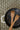 Black frying pan with wooden spatulas on a textured surface