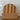 Wooden cutting board with wavy edge on a tiled wall background
