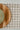 Wooden cutting board on a checkered tablecloth