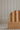 Wooden headboard with wavy design on a neutral background