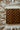 Wooden checkered cutting board on a textured fabric surface