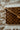 Wooden checkered cutting board on a textured fabric surface