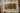 Three wooden cutting boards on a striped fabric surface