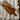 Wooden spatula on a striped fabric surface