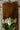White tulips on a wooden cutting board with a striped fabric background