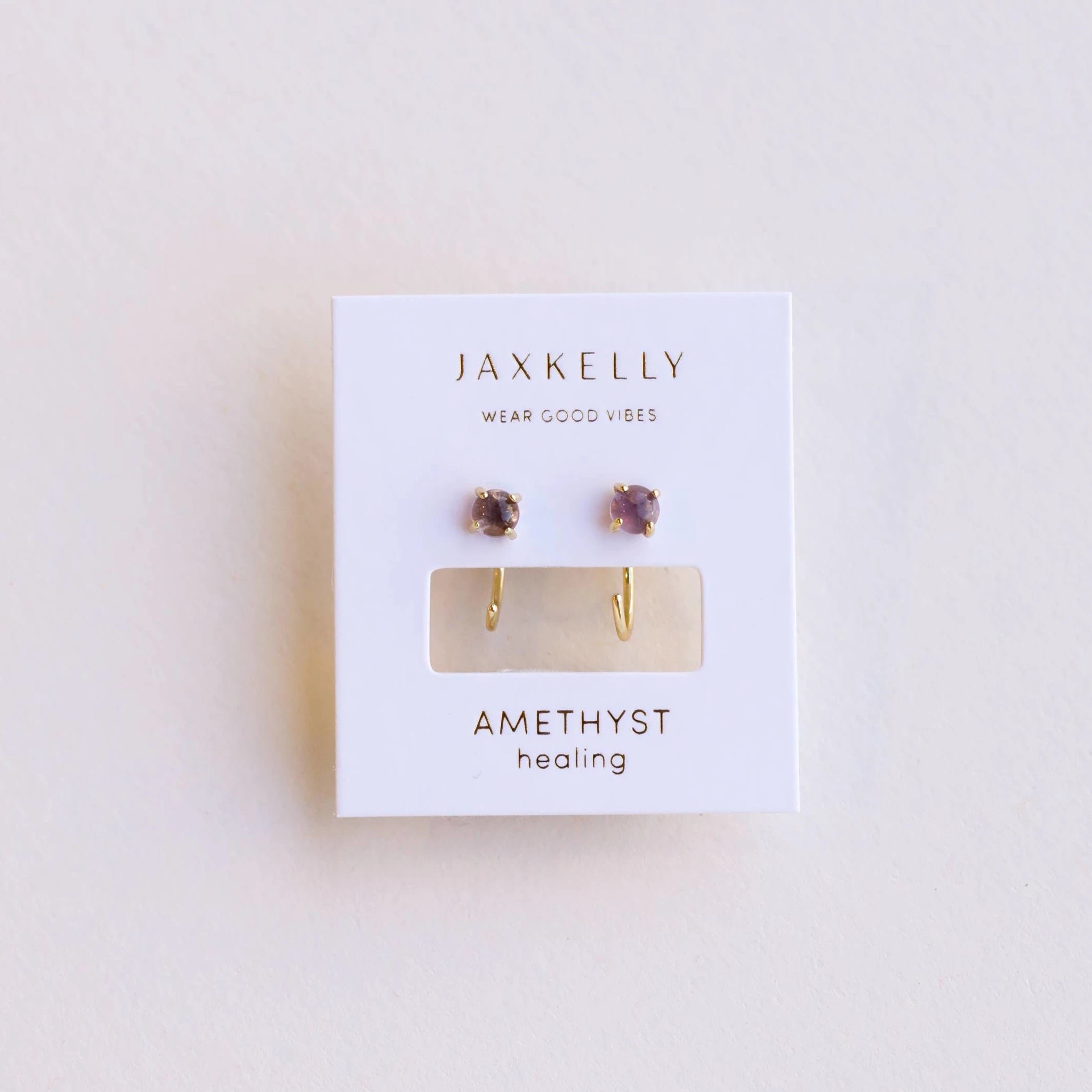 JaxKelly amethyst huggies earrings.