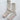 Pair of beige socks with pink accents on a light gray background