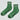 Green socks with white stripes and 'Le Bon Shoppe' branding on a light gray background