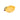 Yellow ceramic measuring cup shaped like a lemon on a white background