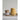 Set of lemon shaped measuring cups stacked next to a jar of marmalade on a light gray surface.