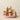 A pink stoneware platter filled with pink, green and yellow accented goods including a jar of lime curd sauce.